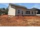 Home's rear elevation features several windows for natural light and a door for easy backyard access at 3536 Dogwood Pass, Stonecrest, GA 30038