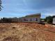 Home's rear elevation features several windows for natural light and a door for easy backyard access at 3536 Dogwood Pass, Stonecrest, GA 30038