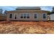 Home's rear elevation features several windows for natural light and a door for easy backyard access at 3536 Dogwood Pass, Stonecrest, GA 30038