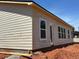 Home's rear elevation features several windows for natural light and a door for easy backyard access at 3536 Dogwood Pass, Stonecrest, GA 30038