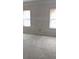 An empty room with two windows, still under construction and awaiting completion with flooring and other finishes at 3536 Dogwood Pass, Stonecrest, GA 30038
