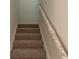 Carpeted staircase with wrapped handrail at 3536 Dogwood Pass, Stonecrest, GA 30038