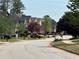 A tree-lined street showcasing diverse home styles and well-kept landscaping enhances the community's charm at 3536 Dogwood Pass, Stonecrest, GA 30038