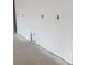 An expansive, unfinished white wall with visible outlet placements, awaiting customization and design at 3536 Dogwood Pass, Stonecrest, GA 30038