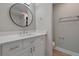 Stylish bathroom featuring white vanity, round mirror, and tiled shower at 111 Fair Haven Se Way, Smyrna, GA 30080