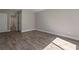 Bedroom showcases wood-look flooring, an open ensuite bath, plus a closet and neutral wall paint at 111 Fair Haven Se Way, Smyrna, GA 30080