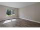 Sunlit bedroom featuring stylish floors and a large window at 111 Fair Haven Se Way, Smyrna, GA 30080