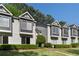 Exterior view of townhomes with gray and white siding, decorative windows, and well-maintained landscaping at 111 Fair Haven Se Way, Smyrna, GA 30080