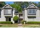 A charming townhome exterior with gray and white siding, decorative windows and manicured landscaping at 111 Fair Haven Se Way, Smyrna, GA 30080