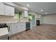 Open-concept kitchen with white cabinets, stainless appliances and views into the living space at 111 Fair Haven Se Way, Smyrna, GA 30080