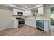 Modern kitchen featuring stainless steel appliances, white cabinetry, and hardwood floors at 111 Fair Haven Se Way, Smyrna, GA 30080