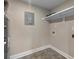 Simple laundry area with tile flooring and shelf for storage at 111 Fair Haven Se Way, Smyrna, GA 30080
