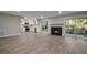 Open living room with fireplace and patio doors leading to an outdoor space at 111 Fair Haven Se Way, Smyrna, GA 30080
