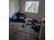 Image exhibits a bedroom interior with garbage, debris, and items scattered throughout at 1316 Camelot Dr, College Park, GA 30349