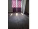 Bright bedroom with wood flooring, a large window, and purple curtains at 1316 Camelot Dr, College Park, GA 30349