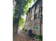 Exterior view of a house with brick and siding with mature trees at 1316 Camelot Dr, College Park, GA 30349
