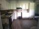 Shows the kitchen with dated cabinetry and flooring in need of repair or replacement at 1316 Camelot Dr, College Park, GA 30349