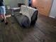 Reveals a living room with a partially covered sofa and damaged walls in need of repair and refurbishment at 1316 Camelot Dr, College Park, GA 30349