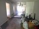 This image shows the interior of a living room filled with unwanted items and debris at 1316 Camelot Dr, College Park, GA 30349