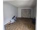 Depicts a vacant living room with hardwood floors, bare walls, and minimal fixtures at 1316 Camelot Dr, College Park, GA 30349