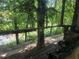 Features a run-down porch, overgrown foliage, and the potential for a scenic view despite disrepair at 1316 Camelot Dr, College Park, GA 30349
