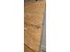 Close-up of a plywood wall, revealing unfinished space and construction elements within a property for potential renovation at 1316 Camelot Dr, College Park, GA 30349