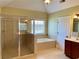 Bathroom featuring a walk in shower, tub and tiled floor at 220 Fannin Ln, Mcdonough, GA 30252