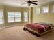 Bedroom featuring carpeted floors, windows, ceiling fan and neutral paint at 220 Fannin Ln, Mcdonough, GA 30252
