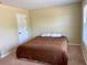 Bedroom featuring tan walls, carpet, and an interior door at 220 Fannin Ln, Mcdonough, GA 30252