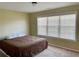 Bedroom featuring a large window with blinds and neutral carpet at 220 Fannin Ln, Mcdonough, GA 30252