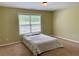 Bedroom featuring carpeted floors and a view from the large window at 220 Fannin Ln, Mcdonough, GA 30252