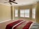 Bedroom featuring carpeted floors, multiple windows, ceiling fan and neutral paint at 220 Fannin Ln, Mcdonough, GA 30252