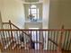 Bright foyer showcasing a chandelier, large window, and staircase with decorative iron railing at 220 Fannin Ln, Mcdonough, GA 30252