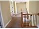 Hallway with carpeting leading to bedrooms with staircase featuring iron railing at 220 Fannin Ln, Mcdonough, GA 30252