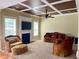 Comfortable living room featuring a fireplace, plush seating, and a coffered ceiling at 220 Fannin Ln, Mcdonough, GA 30252