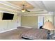 Spacious main bedroom featuring trey ceiling and neutral carpeting at 220 Fannin Ln, Mcdonough, GA 30252