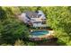 Beautiful backyard featuring a large pool, deck and surrounded by mature trees at 4820 Coppedge Trl, Peachtree Corners, GA 30096