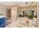 Spacious bathroom with a sunken tub, large mirrors, floral wallpaper, and a separate shower, offering a relaxing retreat at 4820 Coppedge Trl, Peachtree Corners, GA 30096