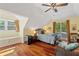 Sunlit bedroom features a cozy window nook, hardwood floors, and natural light from the sliding door at 4820 Coppedge Trl, Peachtree Corners, GA 30096