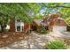 Charming red brick home with lush landscaping and a welcoming driveway at 4820 Coppedge Trl, Peachtree Corners, GA 30096