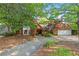 Traditional brick home with attached two-car garage, driveway, and mature trees at 4820 Coppedge Trl, Peachtree Corners, GA 30096