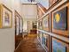 Charming hallway with brick flooring and an array of framed artwork adorning the walls, creating a gallery-like ambiance at 4820 Coppedge Trl, Peachtree Corners, GA 30096