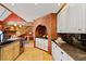 Kitchen features a brick archway, white cabinets and stone countertops at 4820 Coppedge Trl, Peachtree Corners, GA 30096