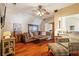 Comfortable living room features hardwood floors, large couch, cozy armchair, and a ceiling fan at 4820 Coppedge Trl, Peachtree Corners, GA 30096