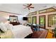 Comfortable main bedroom featuring hardwood floors, french doors to an outside patio, and a ceiling fan at 4820 Coppedge Trl, Peachtree Corners, GA 30096