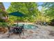 Beautiful pool area with stone patio, lounge chairs, and dining table, ideal for relaxation and outdoor entertaining at 4820 Coppedge Trl, Peachtree Corners, GA 30096