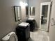 Bathroom featuring double sinks with modern fixtures, framed mirrors, and a combination shower and bathtub at 5147 Roswell Rd # 9, Atlanta, GA 30342