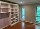 Bedroom with built-in shelving, wood floors and two windows at 5147 Roswell Rd # 9, Atlanta, GA 30342