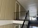 Exterior landing and entry to a unit featuring neutral siding and black railings at 5147 Roswell Rd # 9, Atlanta, GA 30342