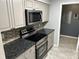 Well-equipped kitchen with stainless steel appliances and gray cabinets at 5147 Roswell Rd # 9, Atlanta, GA 30342
